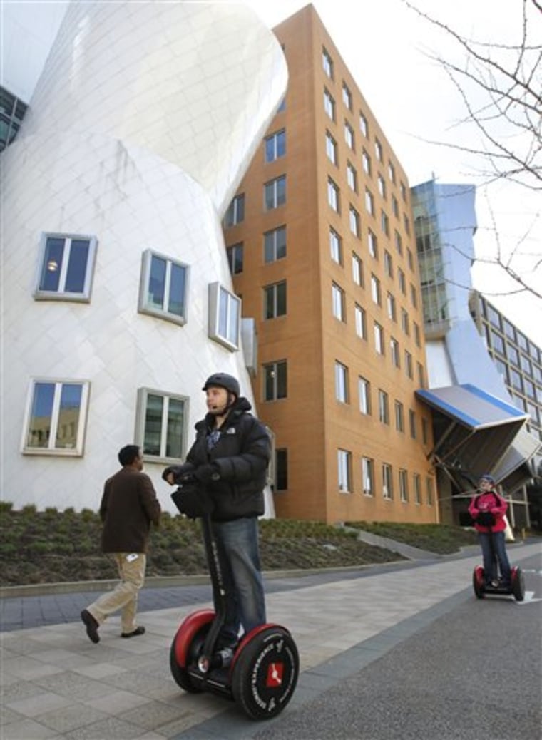 Waldo Holtzhausen of Medfield, Mass., front, rides a Segway past Massachusetts Institute of Technology buildings April 15 during a Museum of Science tour in Cambridge, Mass. The tour visits shoreline areas along the Charles River, as well as various stops on and around the MIT campus. 